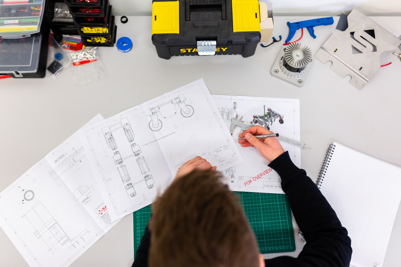 Engineer reviewing control panel schematics and drawings