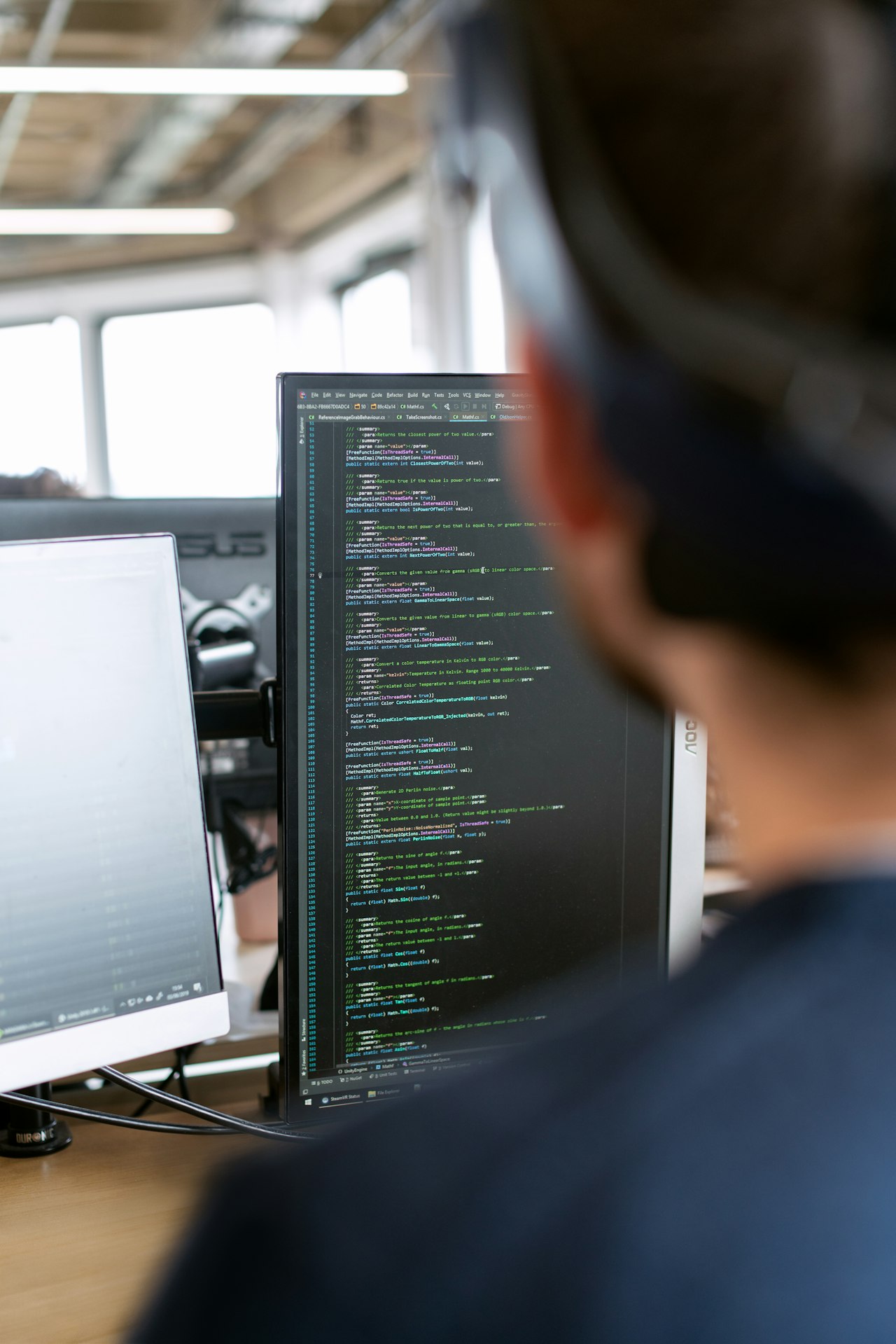 Engineer developing PLC control logic on a workstation